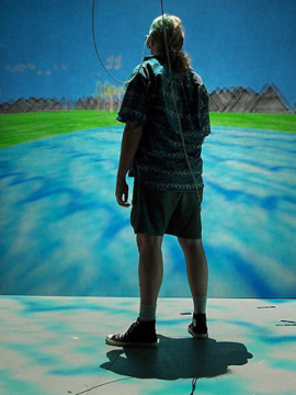 VR user inside a virtual cave blues and greens on screen