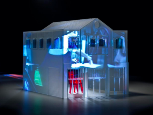 Model of a building with light projection on it 